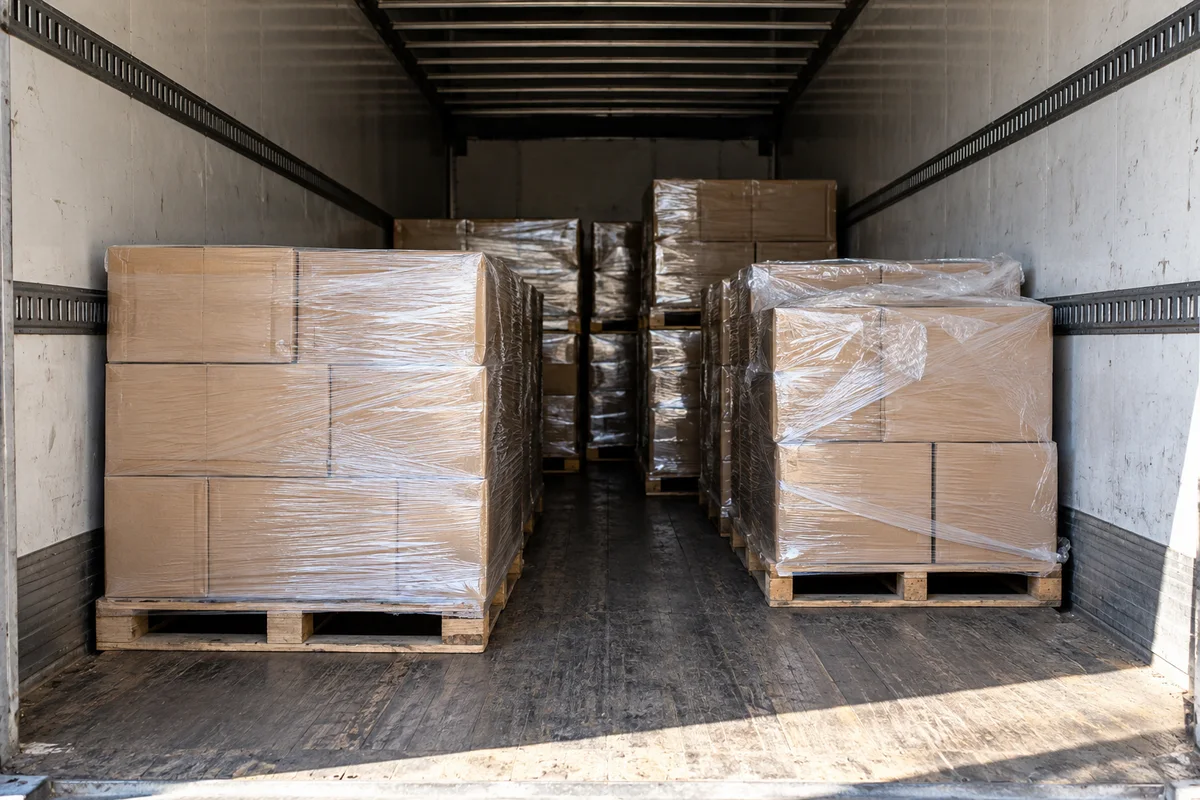 Illustrative AI-generated view of palletized cartons inside a dry van trailer